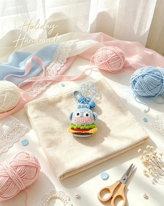 Handmade crochet blue fish burger keychain, styled scene