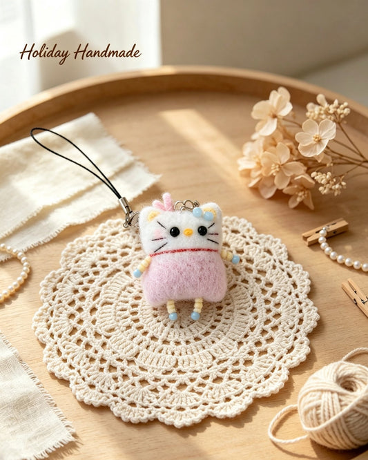 Mini fuzzy crochet kitty charm with pearl chain in a cozy craft scene
