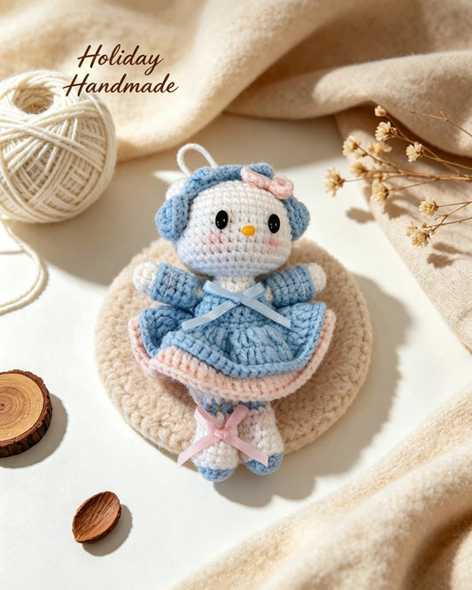 Handmade crochet kitty doll in blue bonnet and dress in a cozy holiday scene