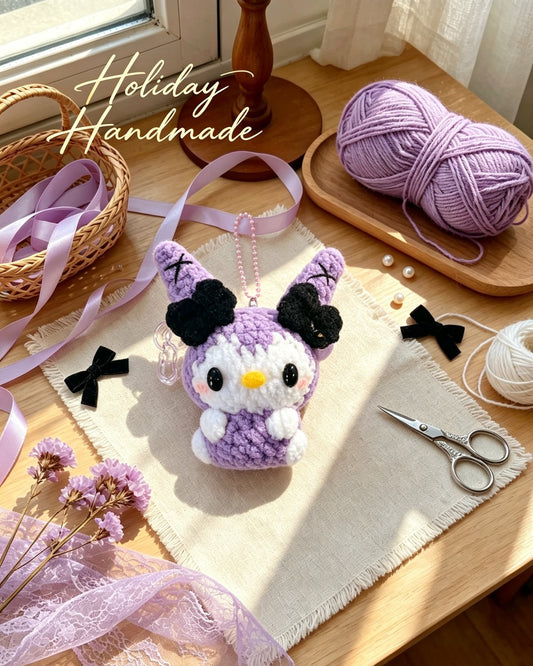 Handmade crochet purple bunny keychain with black bow ears, styled scene